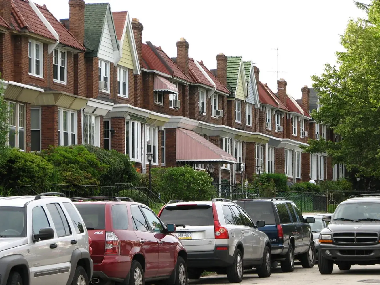 Brick homes on a tree-lined Oak Lane block